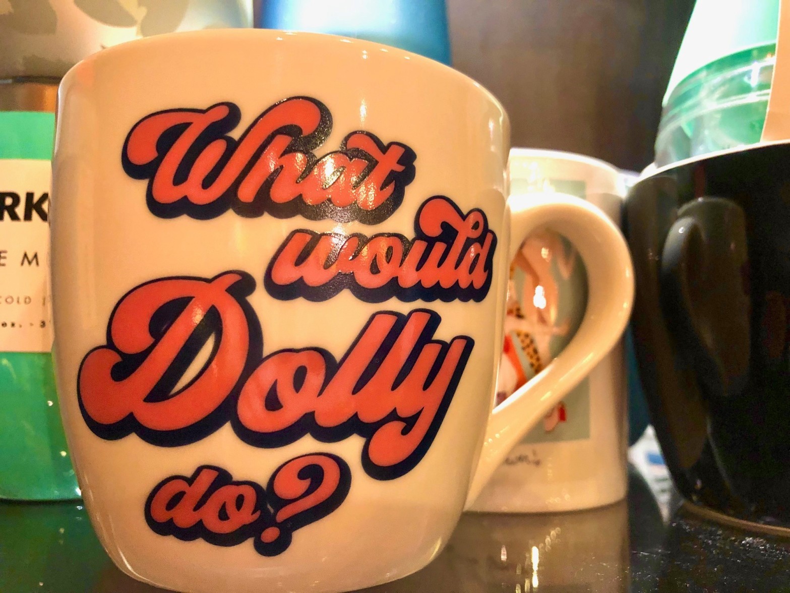 A mug that says What Would Dolly Do?